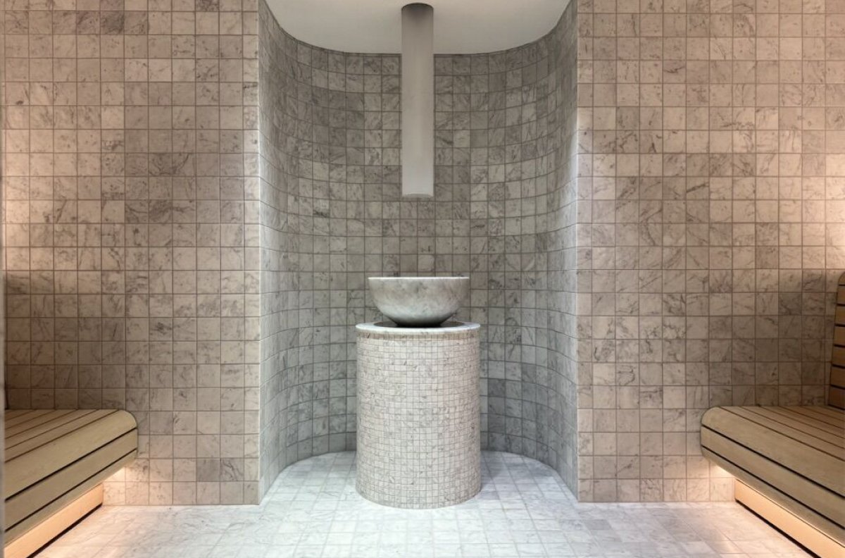 Waldorf Astoria Hotel steam room with marble mosaic and stone basin