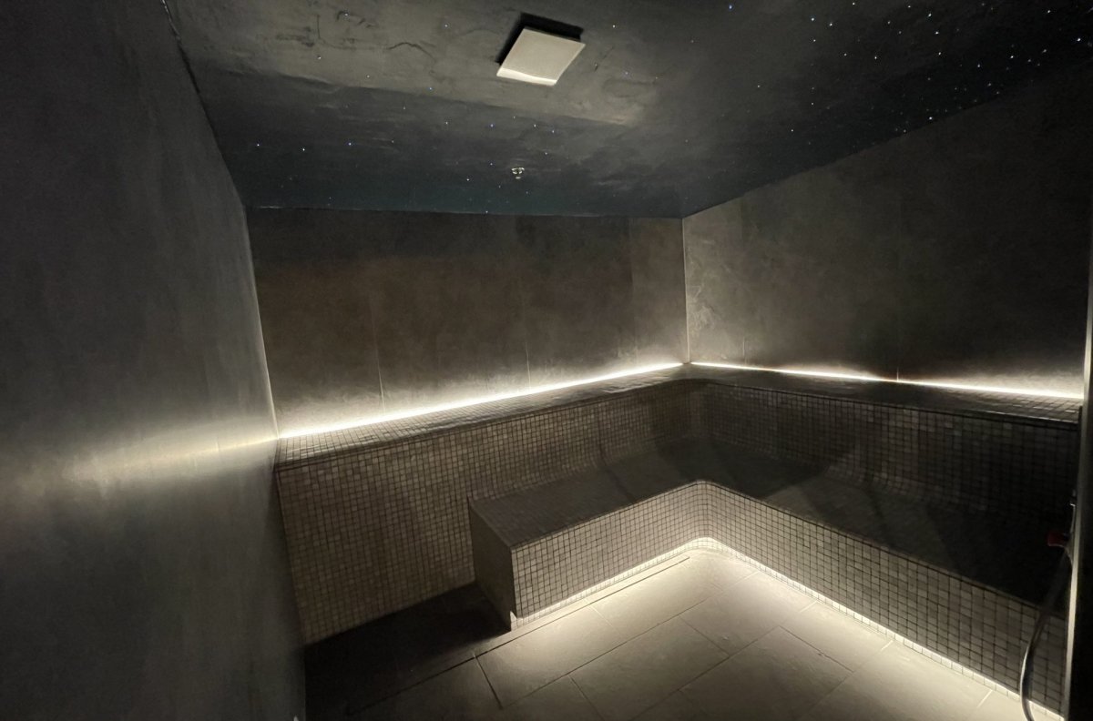 Yuan Spa dark steam room with LED-lit benches
